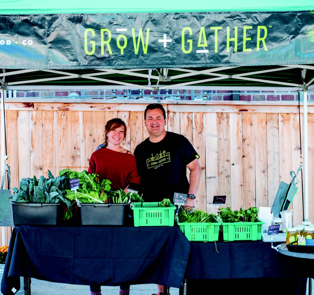 Man and woman selling produce at 2022 grow and father farmers market