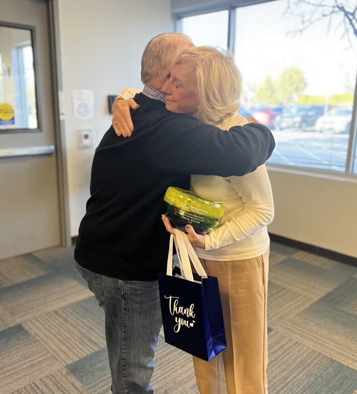 A man giving a hug to a woman